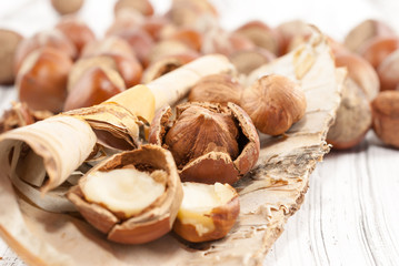 Hazelnuts on white wooden background
