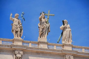 Fototapeta na wymiar Statues on St. Peter's Cathedral facade. Vatican, Rome, Italy