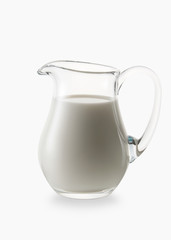 Milk. Glass jug of fresh milk isolated on white background