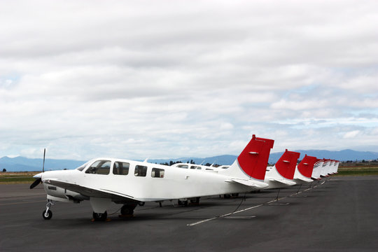 Airplanes standing in row on private parking