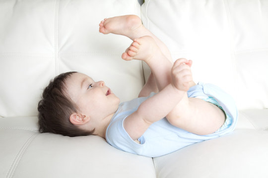 baby boy relaxing in sofa at home