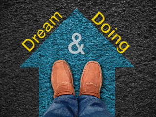 Inspiration quote : " Dream & Doing" on aerial view of shoe on r
