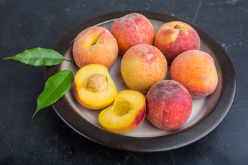 Ripe juicy peaches on a plate ready to eat