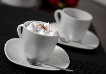 Photo of two coffee cups on a table