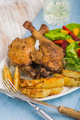 Duck leg with roasted potatoes and fruit salsa