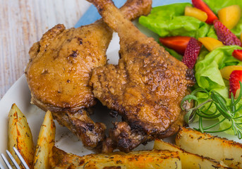 Duck leg with roasted potatoes and fruit salsa