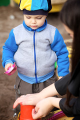 Obraz premium Boy Playing in Sandbox