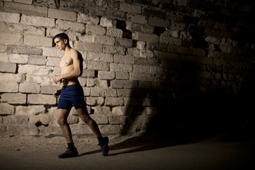 Young athlete warming in tunnel