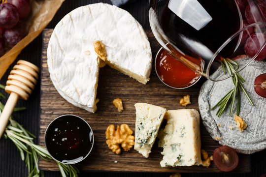Cheese plate served with wine, jam and honey