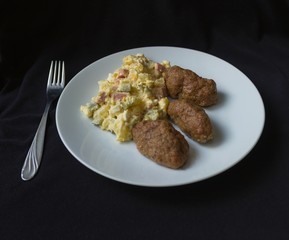 potato salad, meatballs on a white plate