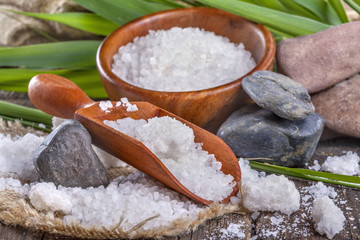 salt bath in wooden bowl with bamboo leaves in background