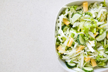 Fresh spring salad made of greeen vegetables and cheese. Space for your text is provided.