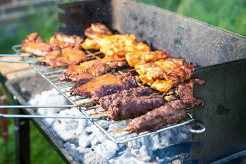 Grilling of various meat varieties in the garden