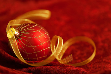 Christmas Ornament & Red Velvet Background with gold ribbon. 
