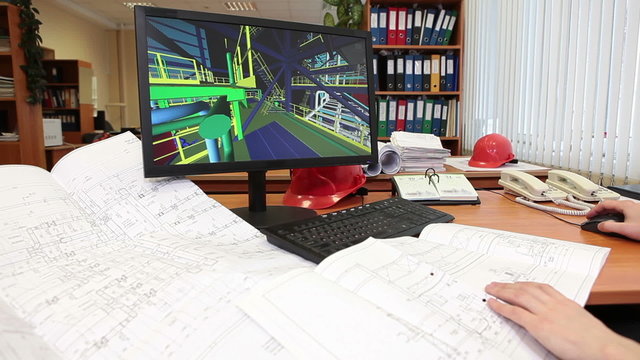 Architect at work, human hands and monitor screen with 3D model of building
