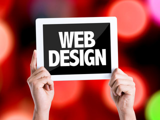 Tablet pc with text Web Design with bokeh background