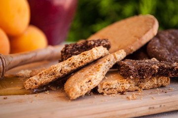 biscuits with honey and honey dipper with milk and fruits