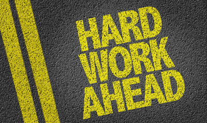 Hard Work Ahead written on the road