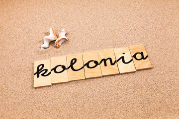 Words formed from small pieces of wood containing a sun and beach tourist destination, kolonia