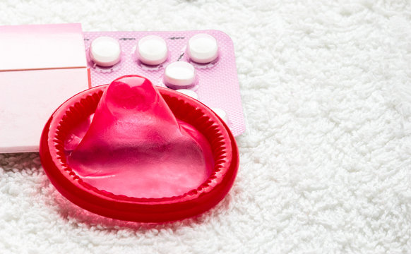 Birth control in pills and condom.