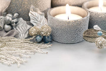Obraz na płótnie Canvas Silver Holiday Theme Christmas candles and vintage style glass beaded ornaments. 