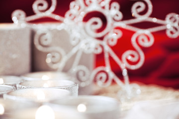 Snowflake & Rows of Candles, silver and red velvet colors. Selective focus used centered on the flames to allow for copy space. 