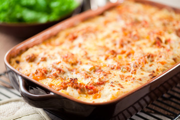 Homemade baked Lasagna in casserole dish. Layered with long simmered ragu, béchamel sauce, noodles and quality parmesan cheese. 