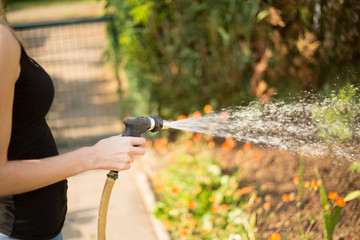 Woman pouring her garden