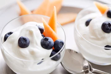 Fototapeten Greek yogurt, blueberries and cantaloupe.  © Denise Torres