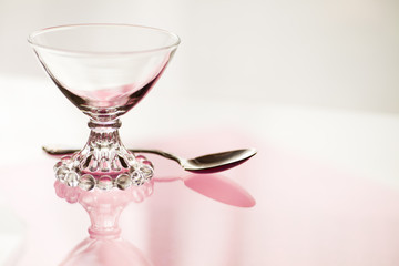 Vintage Glass Dessert Bowl on pink shades on background and reflections in natural daylight. 