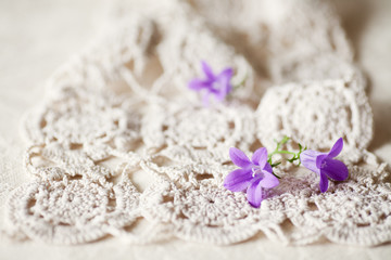 Fototapeta na wymiar Spring Blossoms, Campanula, on a Crocheted Doily