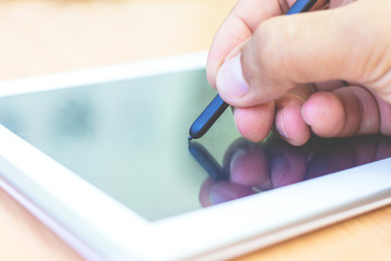 one hand writing on tablet