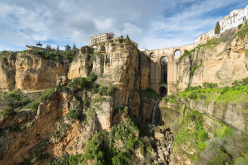 The City of Ronda, Spain. Wide angle view of buildings on sheer cliffs and the Puente Nuevo bridge built over Rio Guadalevin.