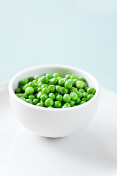 Healthy Green Peas in a white bowl ready to eat. 