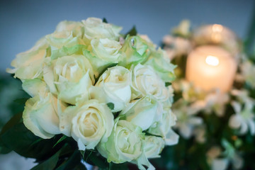 Candle and Wedding bouquet of white roses