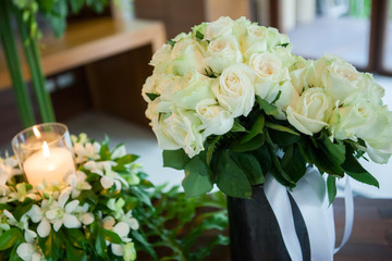 Candle and Wedding bouquet of white roses