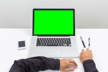 Businessman hands with green screen laptop computer