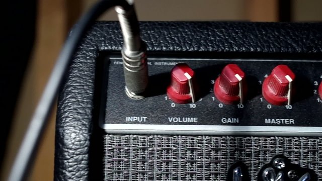 Plugging into an electric guitar amplifier