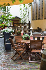Fototapeta na wymiar Romantic outdoor terrace on courtyard with flowers and lanterns