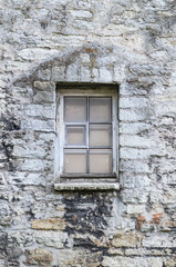 Window in medieval  limestone wall