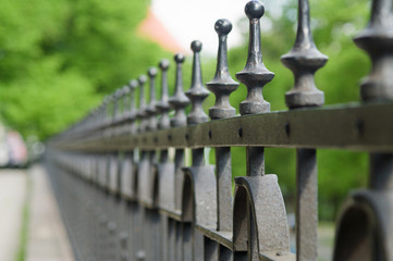 Vanishing line of wrought-iron fence spikes