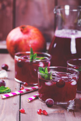 Cranberry and pomegranate cocktail with mint garnish
