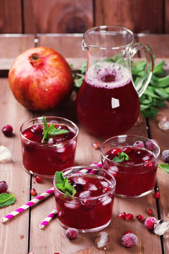 Cranberry and pomegranate cocktail with mint garnish