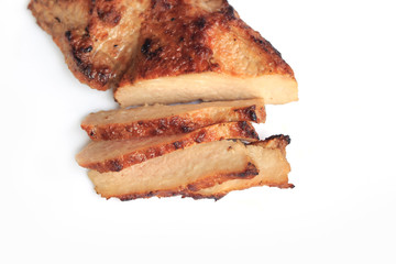 Sliced grilled pork chop on white background