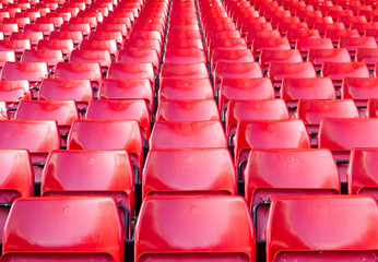 Empty seats red at stadium.