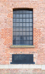 Window and Ventilator on brick wall.