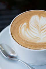 hot coffee latte, latte art with heart in a white cup