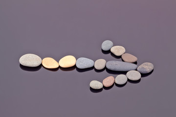 Right arrow lined with sea pebbles