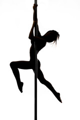 Fototapeta na wymiar Beautiful young woman exercise pole dance against a white background studio shot