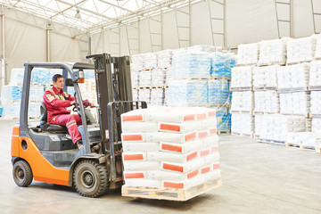 forklift loader working in warehouse  © Kadmy
